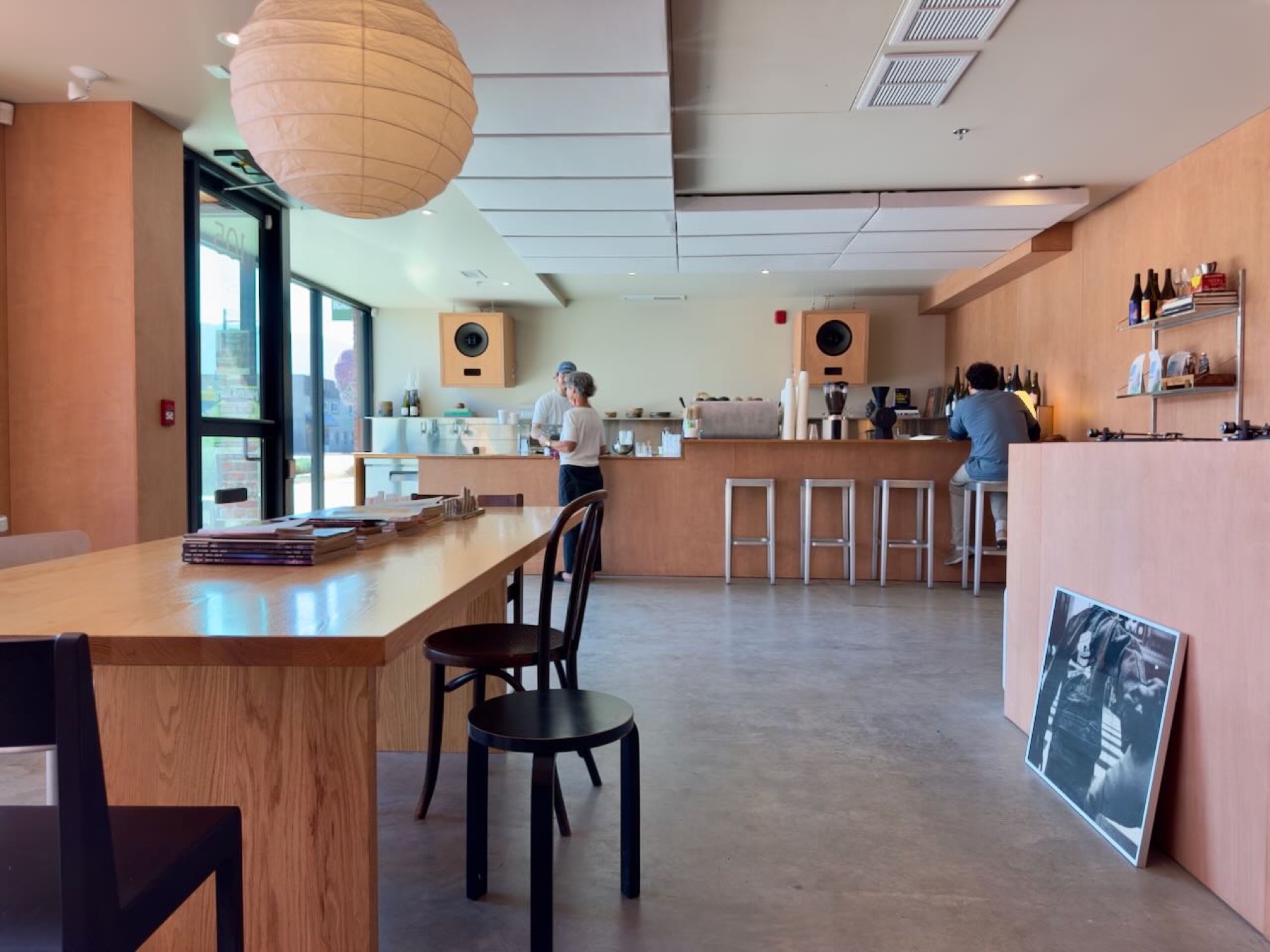 The cafe from the other side, paper lantern over a long wooden table
