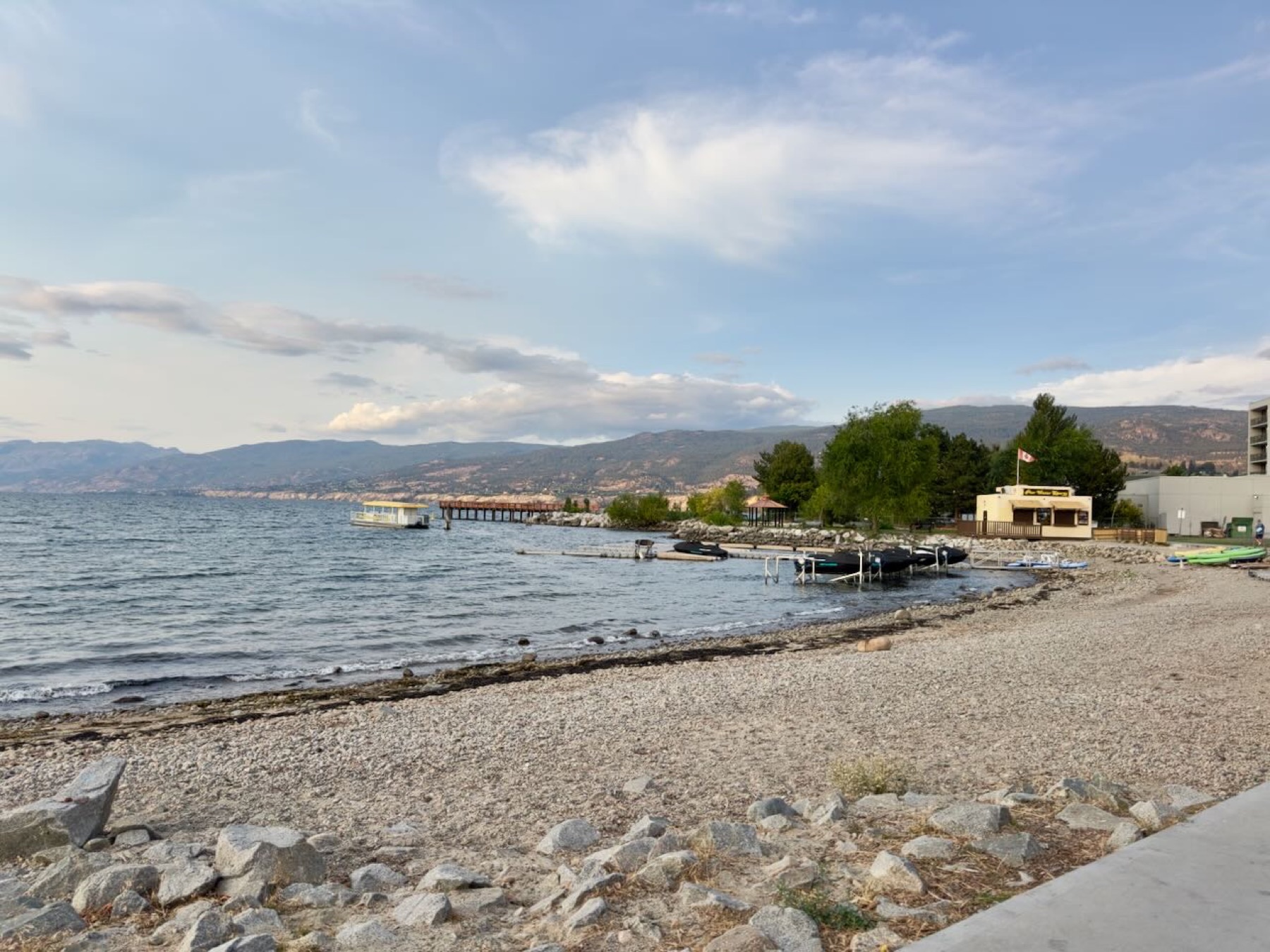 The lake in the late afternoon, pier and boats along the shore